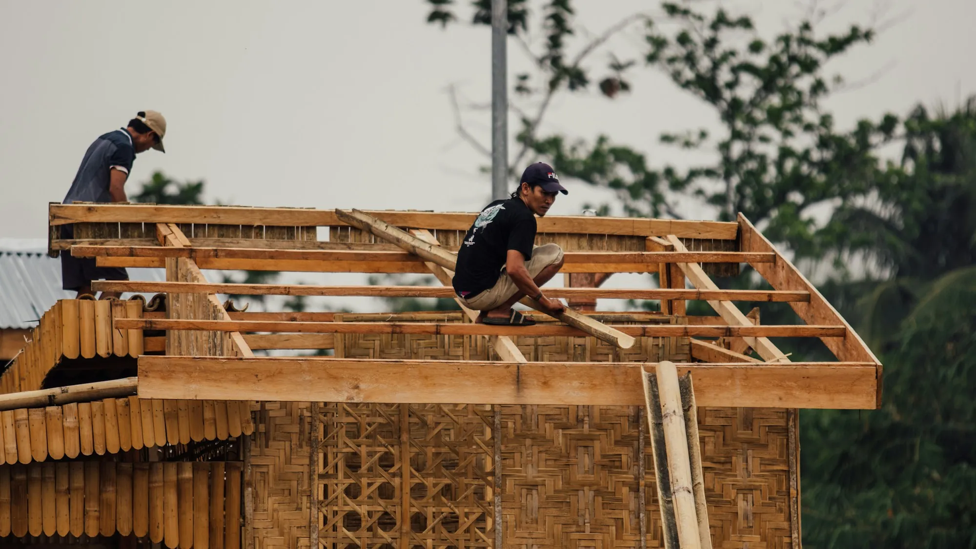 Carpenters framing a new roof structure with wood rafters