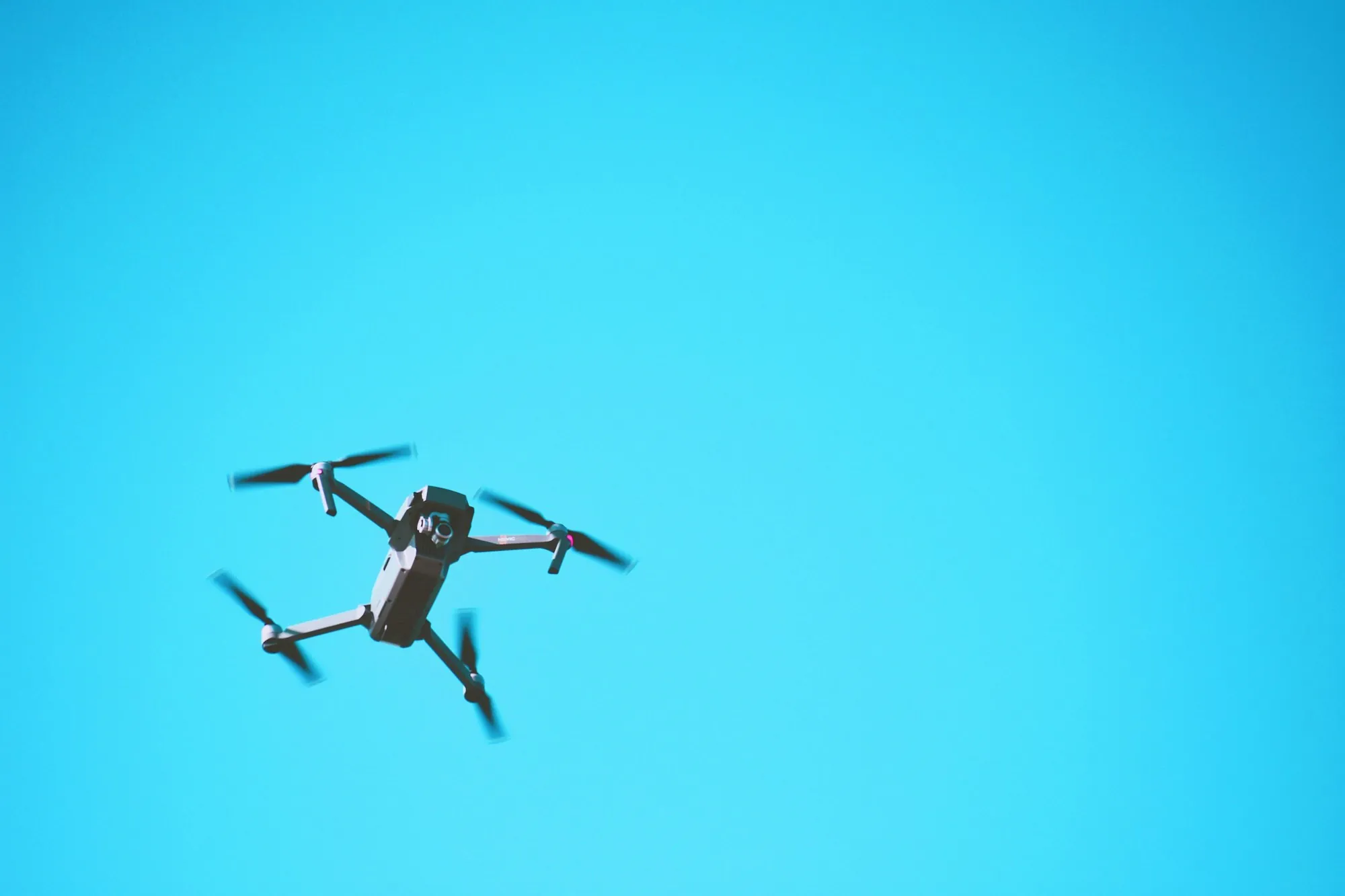 Drone flying in a clear blue sky